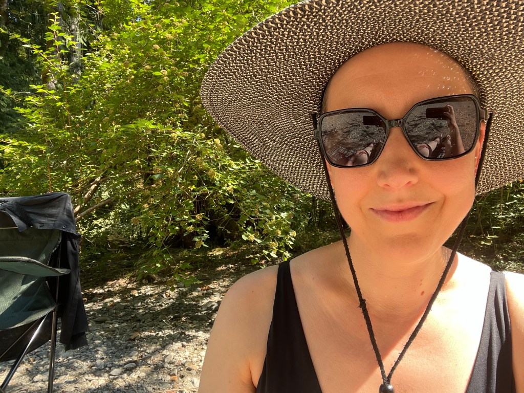 In a black bathing suit by the river